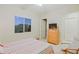 Bright bedroom with a window, chair, dresser, and door leading to the living area at 6044 E Hodges St, Cave Creek, AZ 85331