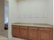 Hallway showcasing granite countertops, plentiful wooden cabinets, and decorative artwork at 6044 E Hodges St, Cave Creek, AZ 85331