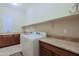 Bright laundry room offers a sink, generous counter space, and modern washer and dryer at 6044 E Hodges St, Cave Creek, AZ 85331