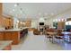 Open concept home featuring a kitchen, dining area and living room with stone fireplace at 6044 E Hodges St, Cave Creek, AZ 85331