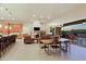 Bright open-concept space with a fireplace, barstool seating, and a covered patio at 6044 E Hodges St, Cave Creek, AZ 85331