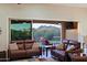 Comfortable living room with an expansive view of the outdoor living space, desert, and mountains beyond at 6044 E Hodges St, Cave Creek, AZ 85331