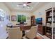 Home office featuring a large wooden desk, ample seating, built-in shelving, and natural lighting at 6044 E Hodges St, Cave Creek, AZ 85331