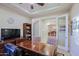 Home office featuring a large wooden desk, ample seating, built-in shelving, and natural lighting at 6044 E Hodges St, Cave Creek, AZ 85331