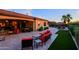 Expansive patio with stylish outdoor furniture, outdoor kitchen, and views of the pool at 6044 E Hodges St, Cave Creek, AZ 85331
