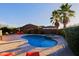 Backyard pool with spa, surrounded by desert landscaping and palm trees at 6044 E Hodges St, Cave Creek, AZ 85331