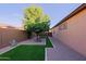 Low-maintenance side yard with artificial turf, gravel, and desert plants at 6044 E Hodges St, Cave Creek, AZ 85331