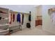 Spacious walk-in closet with shelving, hanging rods, and access to the utility room at 6044 E Hodges St, Cave Creek, AZ 85331