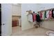 Well-organized walk-in closet with hanging rods, shelving, and access to the laundry room at 6044 E Hodges St, Cave Creek, AZ 85331