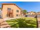 Expansive backyard features a green lawn, mature trees, and is perfect for outdoor enjoyment at 617 N Cobblestone St, Gilbert, AZ 85234