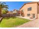 Spacious backyard with lush green grass, and a cozy balcony off the rear of the house at 617 N Cobblestone St, Gilbert, AZ 85234