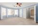 Spacious primary bedroom features large windows, plush carpet, and ensuite access at 617 N Cobblestone St, Gilbert, AZ 85234