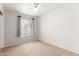 Bright bedroom with large window and a ceiling fan at 617 N Cobblestone St, Gilbert, AZ 85234