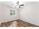 Comfortable bedroom with wood floors, ceiling fan, and natural light at 617 N Cobblestone St, Gilbert, AZ 85234