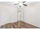 Inviting bedroom features wood floors, ceiling fan, and ensuite access at 617 N Cobblestone St, Gilbert, AZ 85234