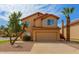 Charming two-story home with desert landscaping, a two-car garage, and a red tile roof at 617 N Cobblestone St, Gilbert, AZ 85234