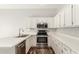 Kitchen with white cabinets, stainless appliances, and ample counter space at 617 N Cobblestone St, Gilbert, AZ 85234