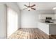 Eat-in kitchen offers wood-look floors, ceiling fan, and access to white cabinets at 617 N Cobblestone St, Gilbert, AZ 85234