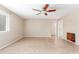 Spacious living room featuring neutral-colored walls, a ceiling fan, and tile flooring at 617 N Cobblestone St, Gilbert, AZ 85234