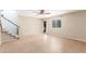 Bright living room features tile flooring, ceiling fan, and staircase to upper level at 617 N Cobblestone St, Gilbert, AZ 85234