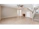 Spacious living room featuring neutral-colored walls, a ceiling fan, and tile flooring at 617 N Cobblestone St, Gilbert, AZ 85234