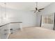 Well lit loft area with neutral colored walls and carpet, a ceiling fan, and large windows at 617 N Cobblestone St, Gilbert, AZ 85234