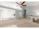 Well lit loft area with neutral colored walls and carpet, a ceiling fan, and open floorplan at 617 N Cobblestone St, Gilbert, AZ 85234
