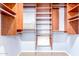 This walk-in closet features custom shelves and ample storage space at 617 N Cobblestone St, Gilbert, AZ 85234
