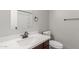 Bathroom with a quartz countertop, a dark-brown cabinet and white toilet at 625 N Hamilton St # 36, Chandler, AZ 85225