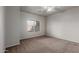 Spacious bedroom with neutral carpet, ceiling fan, and a large window for natural light at 625 N Hamilton St # 36, Chandler, AZ 85225