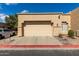 Beige two-car garage attached to a single-story home with desert landscaping and a red painted curb at 625 N Hamilton St # 36, Chandler, AZ 85225