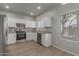 Modern kitchen with white cabinets, stainless steel appliances, and granite countertops and backsplash at 625 N Hamilton St # 36, Chandler, AZ 85225