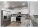 Bright kitchen boasting granite countertops, white cabinets, stainless steel appliances, and recessed lighting at 625 N Hamilton St # 36, Chandler, AZ 85225