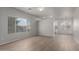 Open-concept living room featuring wood floors, large windows, and a view into the kitchen and dining area at 625 N Hamilton St # 36, Chandler, AZ 85225