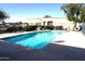 Refreshing community pool with crystal-clear water, shaded table, and lounge area at 625 N Hamilton St # 36, Chandler, AZ 85225