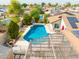 Aerial shot of a house with a pool, patio, shed, and verdant landscaping at 6409 W Riviera Dr, Glendale, AZ 85304