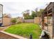Spacious backyard with green lawn, shed, patio cover, and privacy fence at 6409 W Riviera Dr, Glendale, AZ 85304