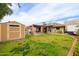 Large backyard with shed, patio, mature trees, and a well-maintained lawn at 6409 W Riviera Dr, Glendale, AZ 85304