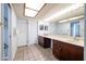 Bright bathroom with a spacious counter and mirror plus ample storage offers convenience and style at 6409 W Riviera Dr, Glendale, AZ 85304