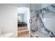 Luxurious bathroom with a modern glass shower and a soaking tub for a spa-like experience, promoting relaxation at 6409 W Riviera Dr, Glendale, AZ 85304