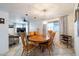 Dining room with large wooden table, seating for six, chandelier, and natural light at 6409 W Riviera Dr, Glendale, AZ 85304