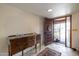 Inviting foyer with decorative tile flooring, classic wooden console table, and a view of the front door at 6409 W Riviera Dr, Glendale, AZ 85304