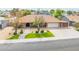 Charming single-story home featuring a manicured front yard, a two-car garage, and a welcoming walkway at 6409 W Riviera Dr, Glendale, AZ 85304