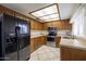 Traditional kitchen with stainless steel appliances, ample cabinet space, and neutral countertops at 6409 W Riviera Dr, Glendale, AZ 85304