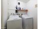 Functional laundry room features a washer, dryer, and overhead storage shelf at 6409 W Riviera Dr, Glendale, AZ 85304