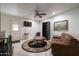 Comfortable living room featuring a ceiling fan, tile floors, and ample space for furniture and relaxation at 6409 W Riviera Dr, Glendale, AZ 85304