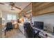 Bright home office featuring built-in shelves, a large desk with cabinets, and comfortable seating at 6409 W Riviera Dr, Glendale, AZ 85304