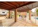 Open patio with pergola cover, dining area, and outdoor grill setup at 6409 W Riviera Dr, Glendale, AZ 85304
