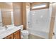 Well-lit bathroom with a single sink vanity, white toilet, and shower-tub combo with shower head at 6792 W Willow Way, Florence, AZ 85132