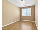 Sunny bedroom with laminate flooring, neutral walls, and bright window at 6792 W Willow Way, Florence, AZ 85132